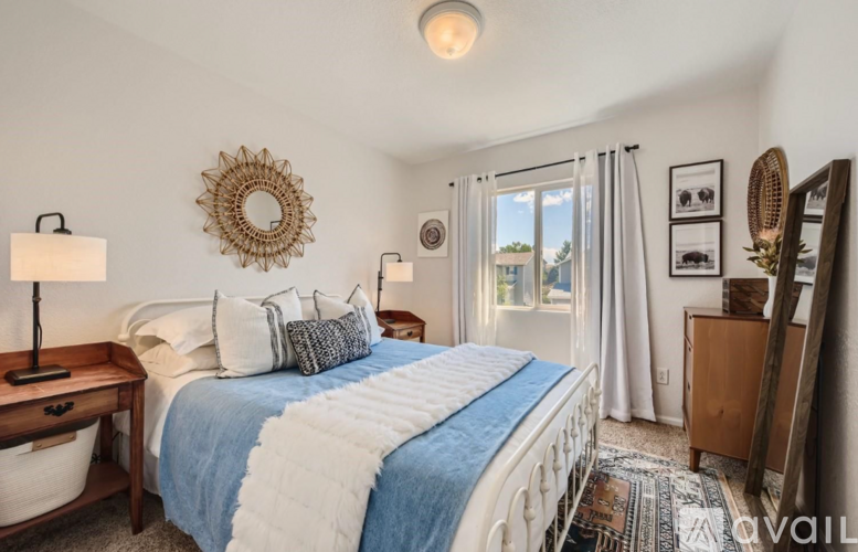 A bedroom with a large bed and a mirror on the wall.