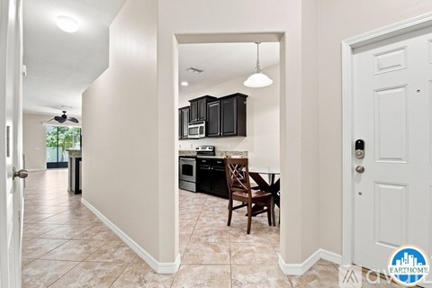 A kitchen with a table and chairs in the middle of the room.