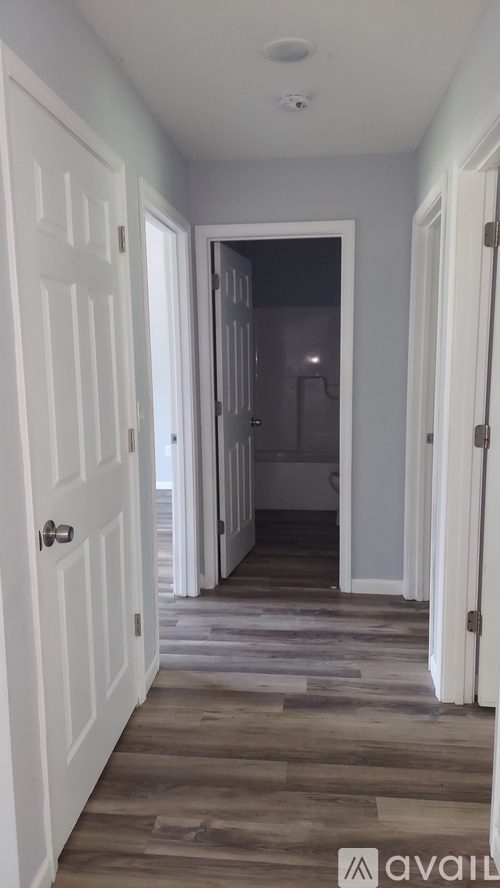 A room with wooden flooring and a window.