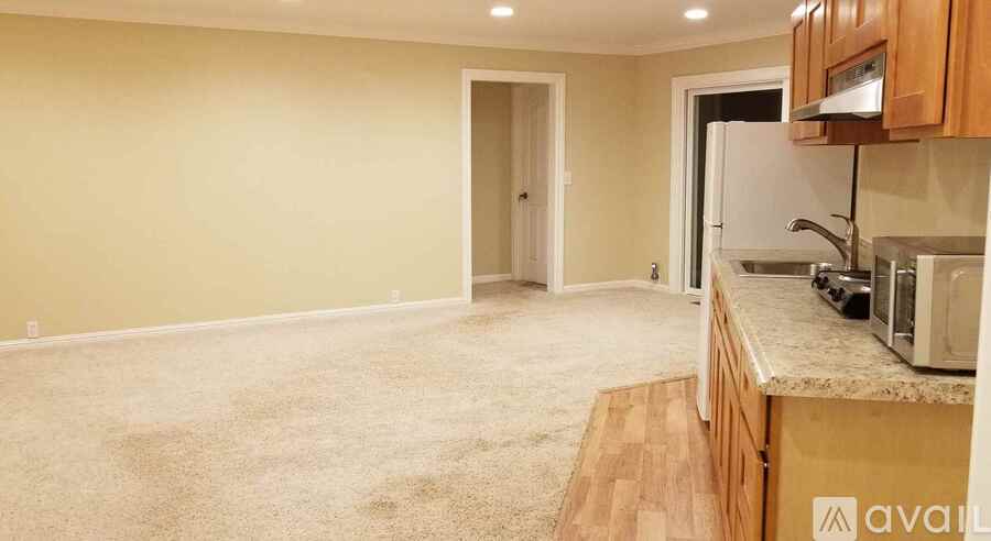 A kitchen area with a counter and cabinets is available for rent.