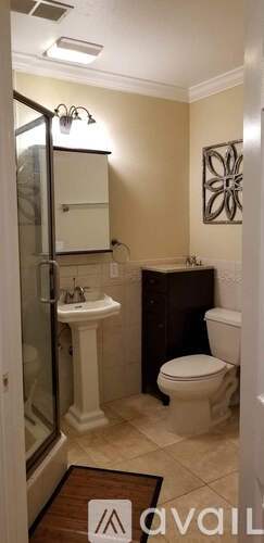 A bathroom with a sink, toilet, and shower.