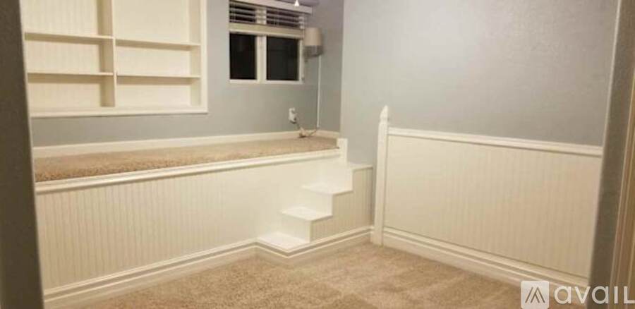 A stairway with a carpeted floor and a wall on the side.