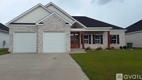 A house with a brick facade and a large garage door.