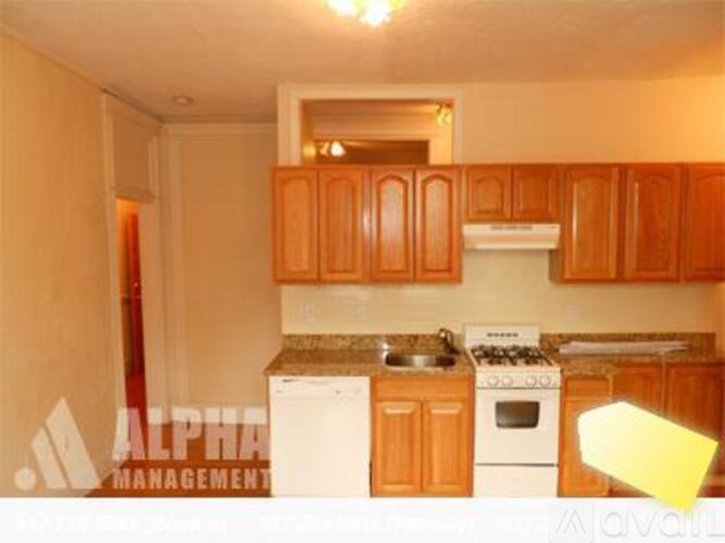 A kitchen with wooden cabinets and a white stove top oven.