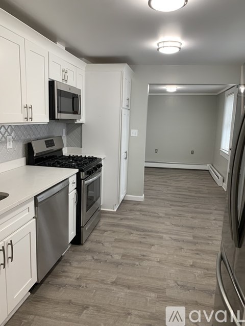 A kitchen with a stove top oven and a microwave.