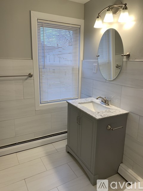 A bathroom with a sink and a mirror.