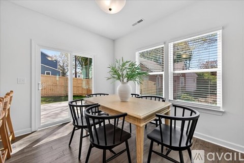A dining room with a wooden table and chairs.