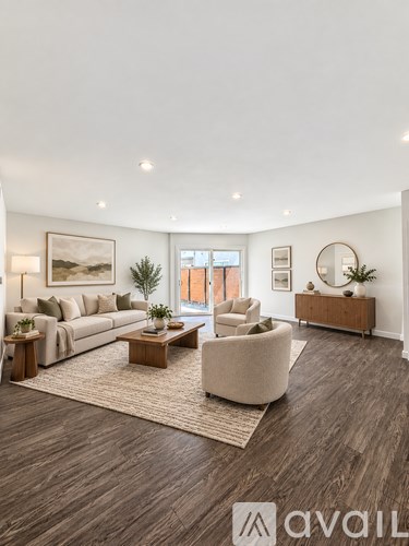 A living room with a large couch, a chair, and a coffee table.