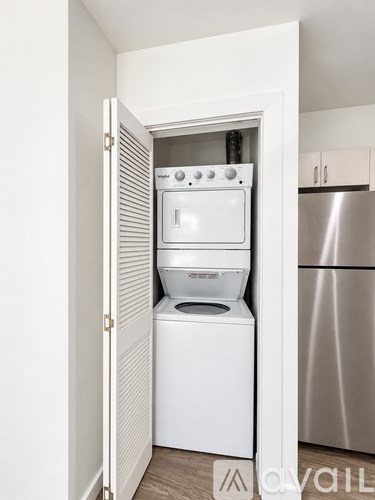 A white dishwasher and oven are built into a kitchen cabinet.