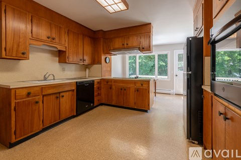 A kitchen with wooden cabinets and appliances.