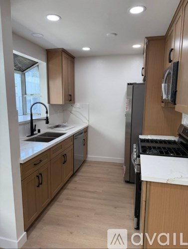 A kitchen with wooden cabinets and a white countertop.