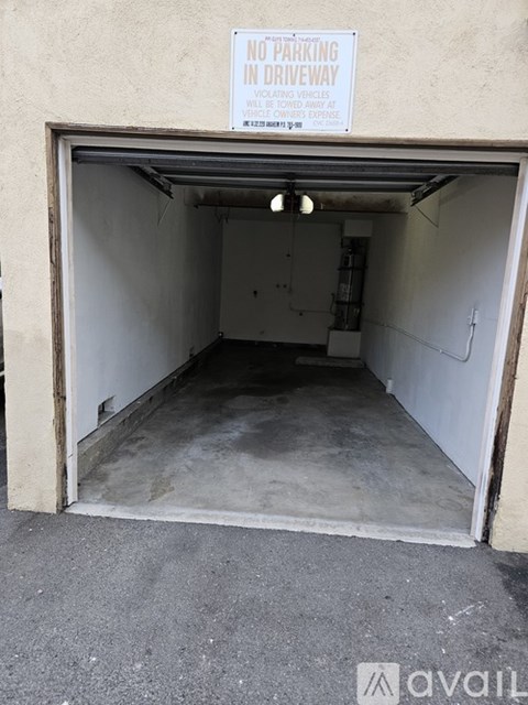 A sign on a garage door reads "No Parking in Driveway.".