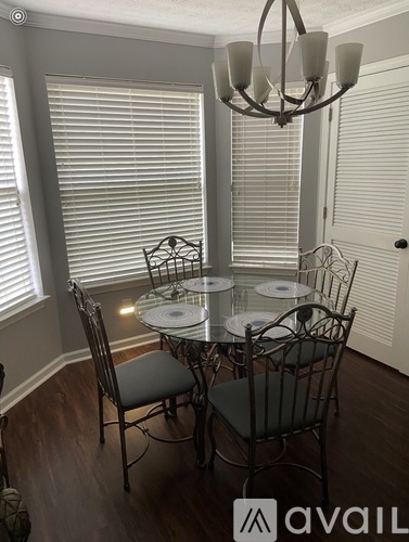 A dining room with a glass table and chairs.