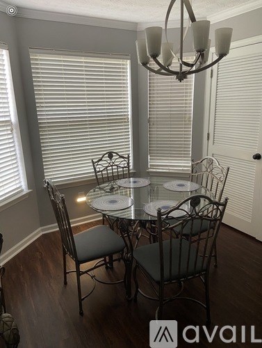 A dining room with a glass table and chairs.