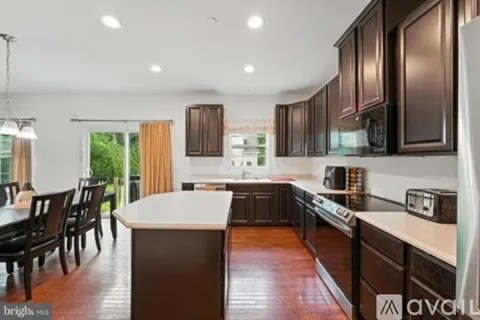 A kitchen with brown cabinets and a white island.