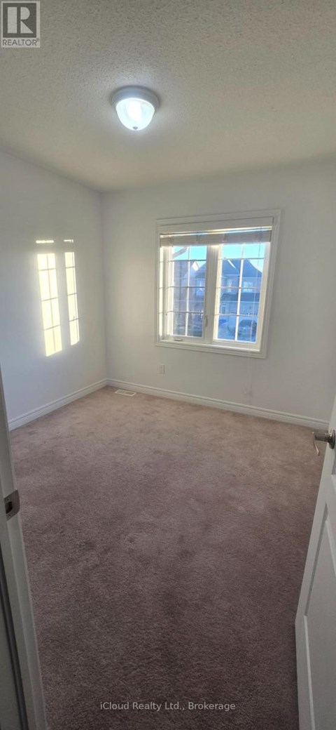 A room with a carpeted floor and a window.