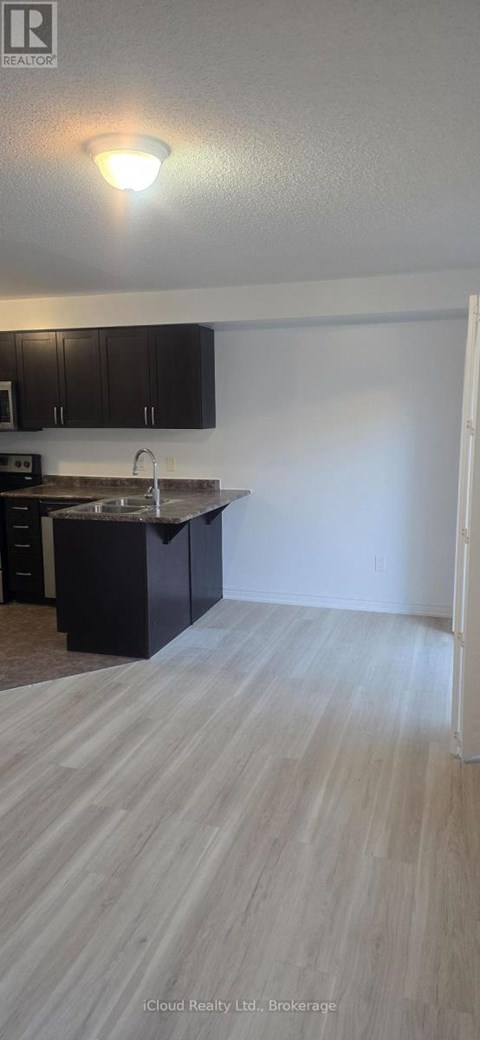 A kitchen with black cabinets and a sink.