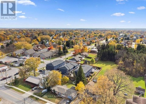 A bird's eye view of a residential neighborhood with houses and trees.