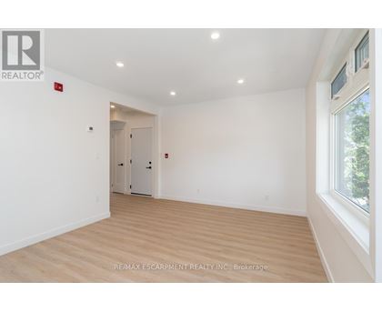 A room with a wooden floor and white walls.