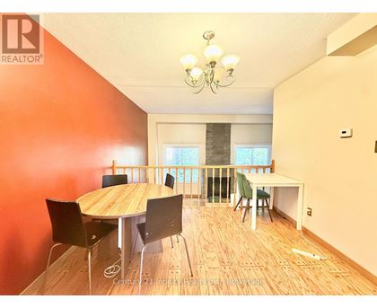 A dining room with a wooden table and chairs.