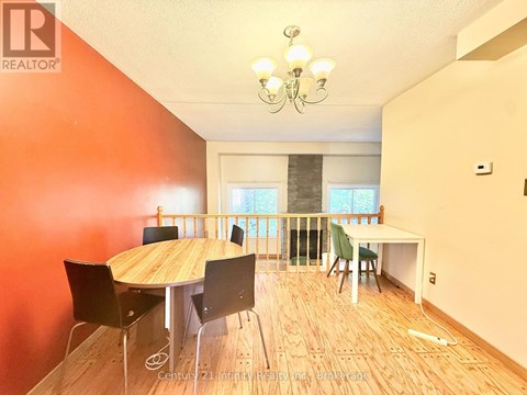 A dining room with a wooden table and chairs.