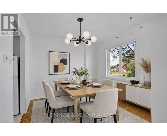 A dining room with a wooden table and chairs.