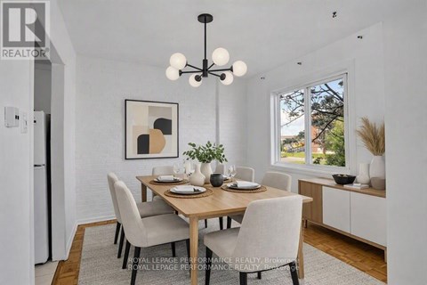 A dining room with a wooden table and chairs.