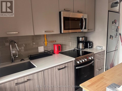 A kitchen with a stove top oven and a microwave above it.