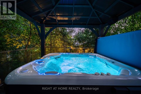 A hot tub in a covered patio area.