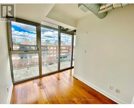 A room with a view of the city through large windows.