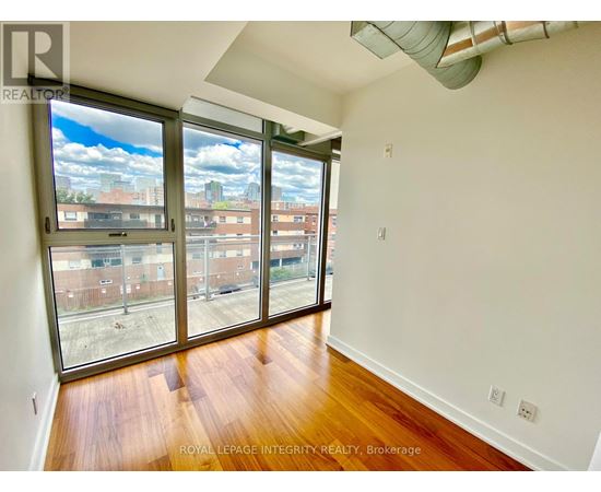 A room with a view of the city through large windows.