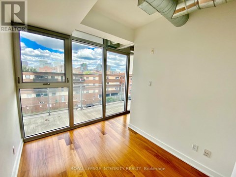 A room with a view of the city through large windows.