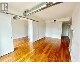 A room with wooden floors and white walls.
