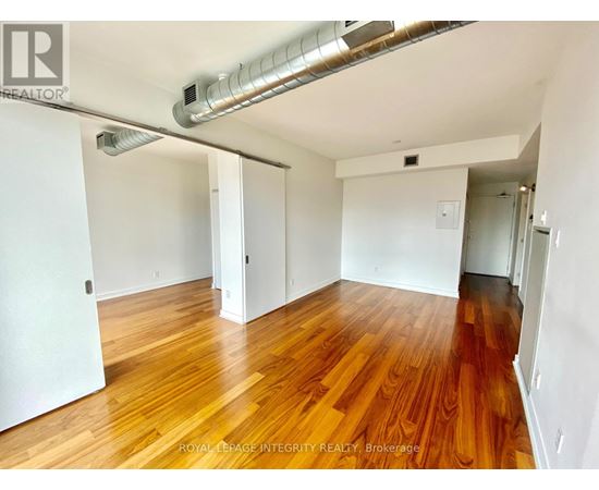 A room with wooden floors and white walls.