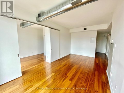 A room with wooden floors and white walls.