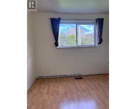 A room with a window and wooden flooring.