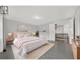 A bedroom with a large bed and a balcony.