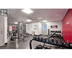A gym with a variety of equipment including dumbbells and weight machines.