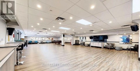 A spacious office with wooden floors and white walls.