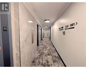 A long hallway with a sign that says REALTOR.
