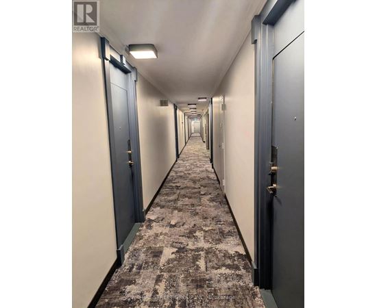 A long hallway with doors on both sides.