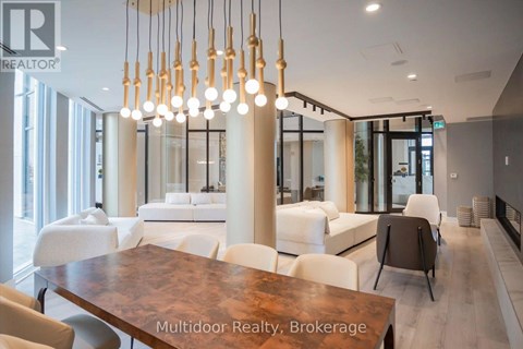 A modern living room with a dining table and chairs.