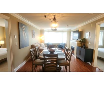 A dining room with a table set for six.