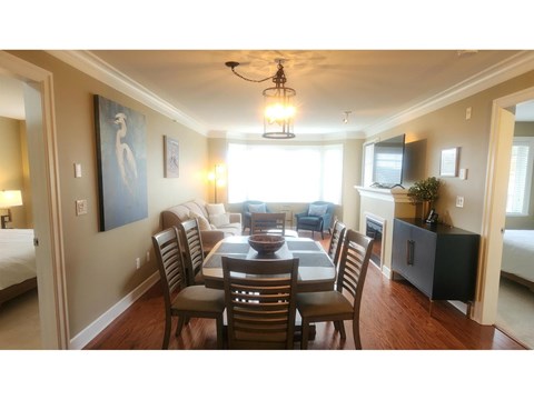 A dining room with a table set for six.