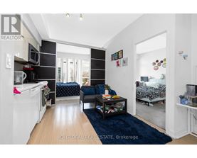 A living room with a couch, a coffee table, and a washing machine.