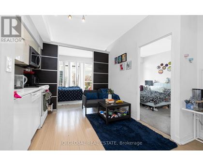 A living room with a couch, a coffee table, and a washing machine.