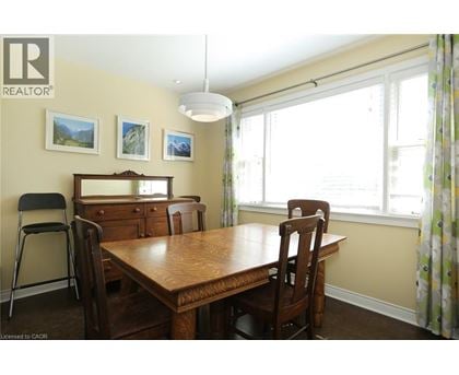 A dining room with a wooden table and chairs.