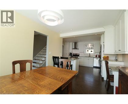 A modern kitchen with a wooden table and chairs.