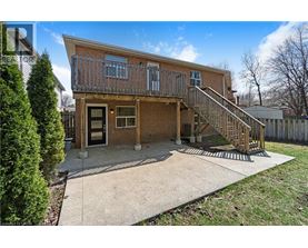 A house with a brown brick exterior and a wooden deck.