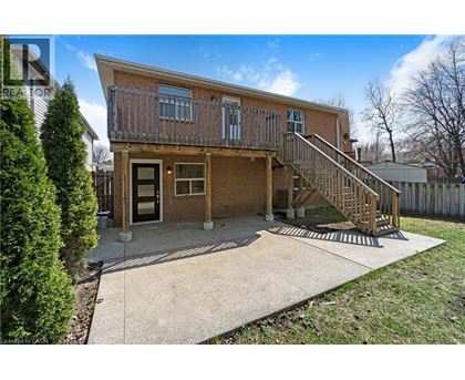 A house with a brown brick exterior and a wooden deck.
